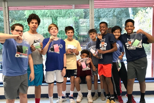 Middle school boys with Blessing Bags they made