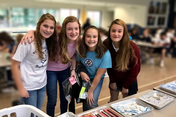 Middle school girls making Blessing Bags