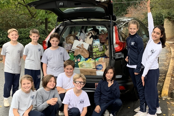 Students with car full of non-perishable items for DEAM