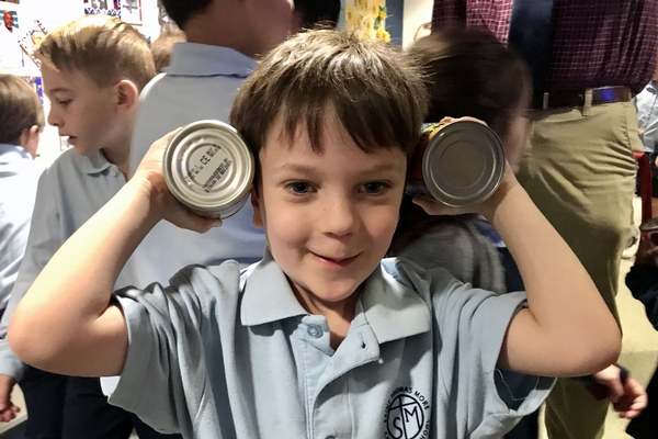 Young boy holding soup cans