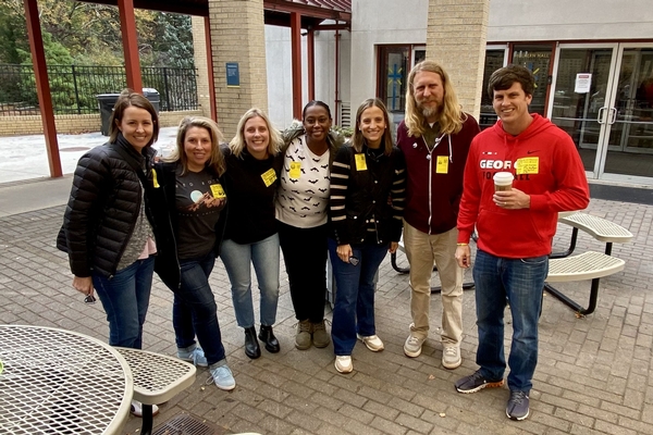 Intermediate parent volunteers outside at Halloween