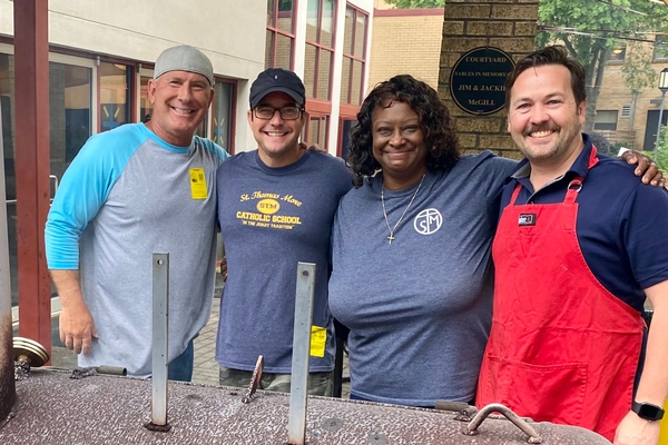 STM's Advancement Director grilling with parent volunteers